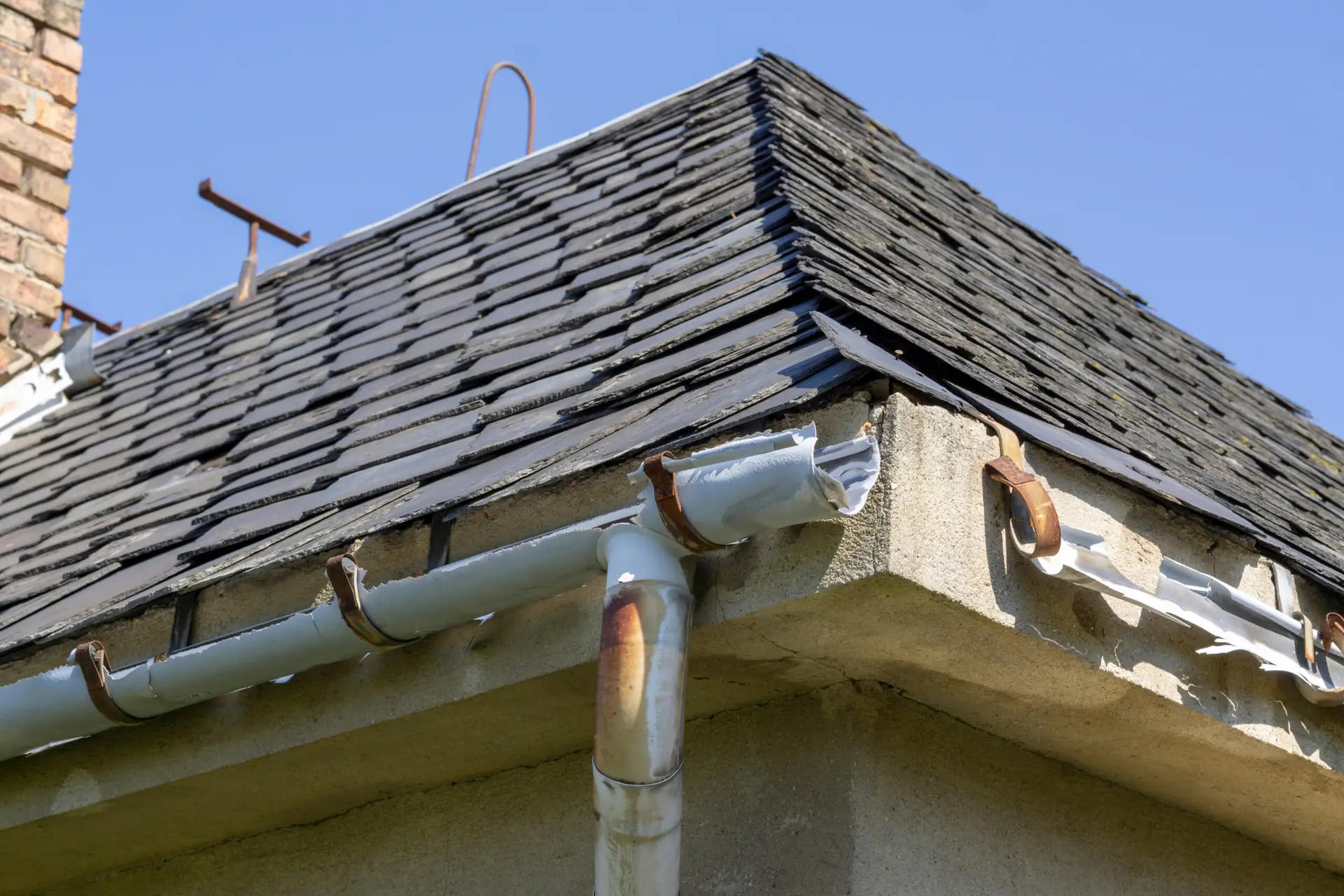Broken gutters on the roof of a house.