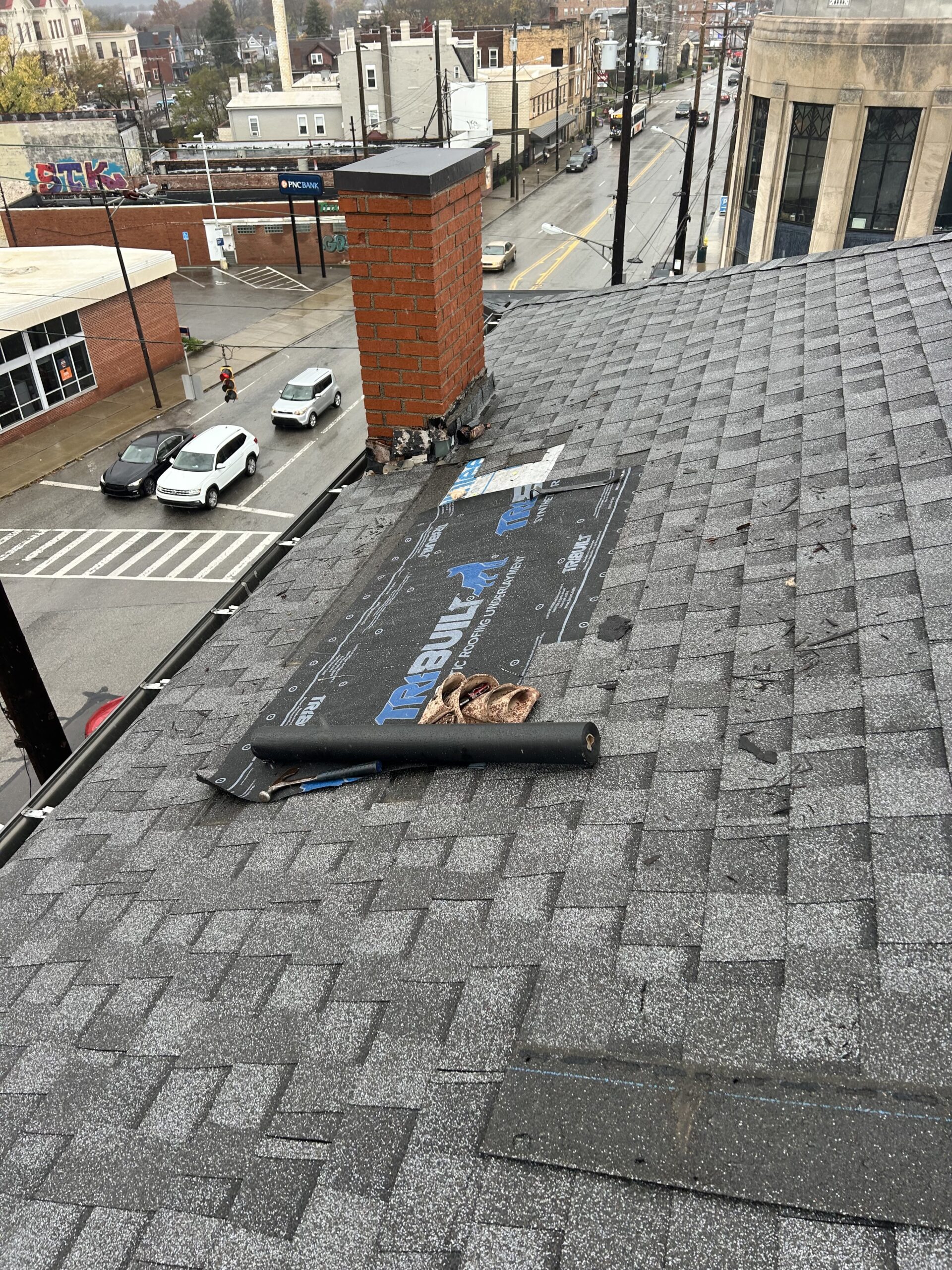 Brightraven applying finishing touches to a shingled roof patch.